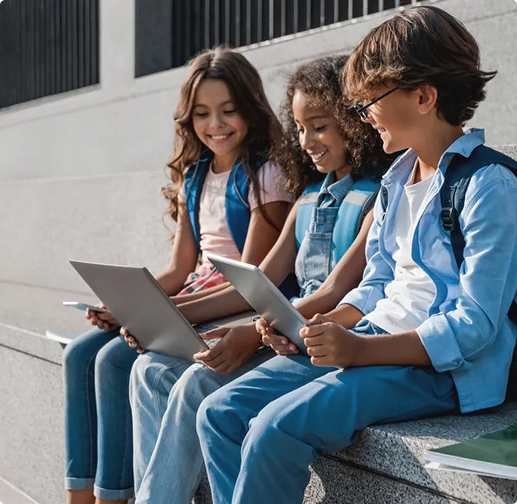 Children writing on a laptop